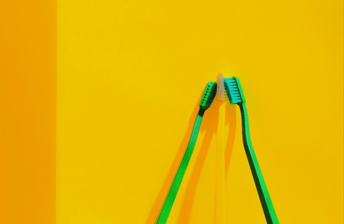 Toothbrushes on a yellow ground